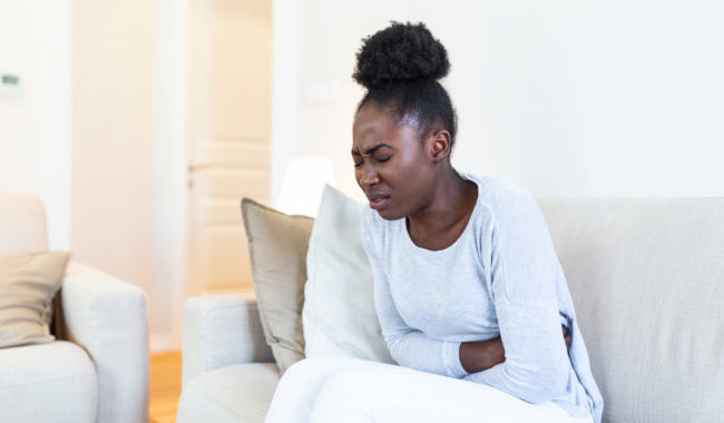 woman folded over in pain